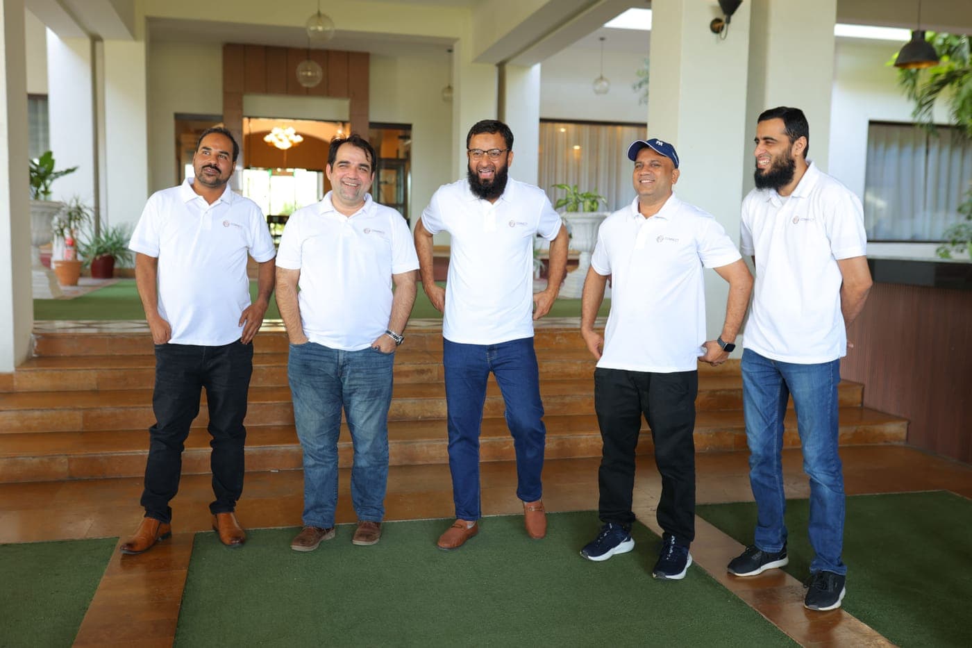 Five colleagues sharing a laugh