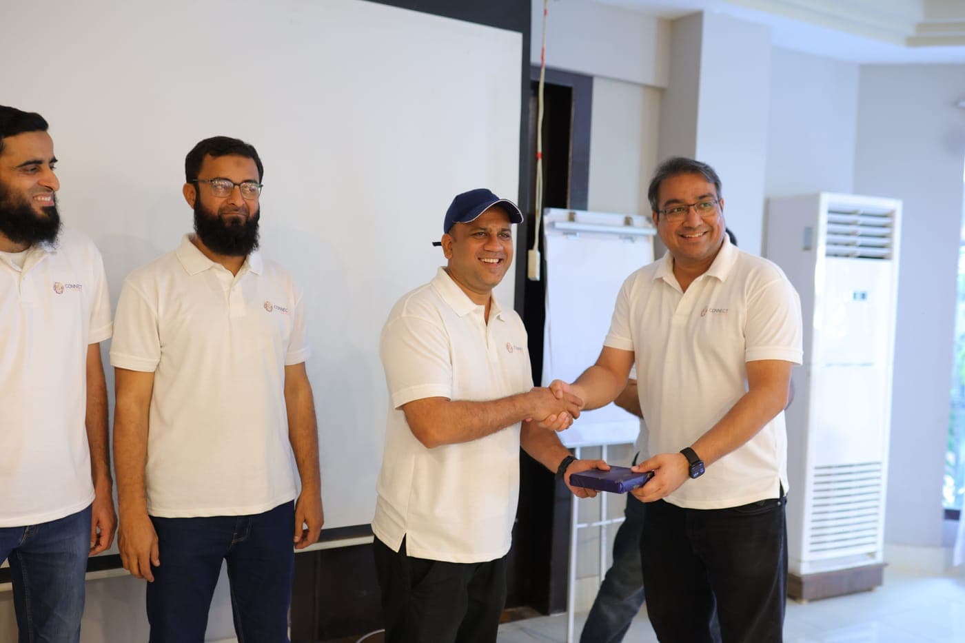A colleague being recognised with a handshake
